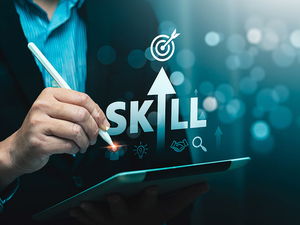 A person in a suit holds a tablet and pen. The word "skill" is stylized so that in place of the letter "i" is an arrow pointing upwards. 