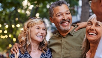 Mature men and women laughing together