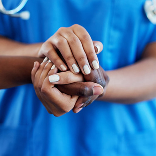 Health professional holding someone's hand