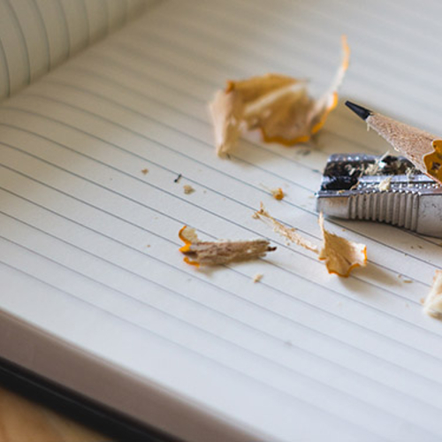 Pencil and sharpener on a blank journal