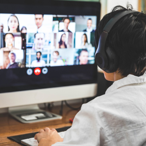 Person wearing a headset participates in a virtual meeting.